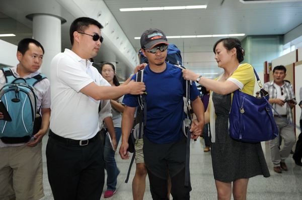 Surviving mountaineer returns to China