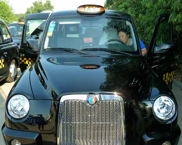 Classic British taxi cabs on road in E China