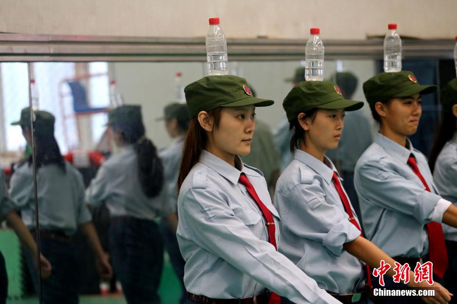 Military training with bottles balanced on heads