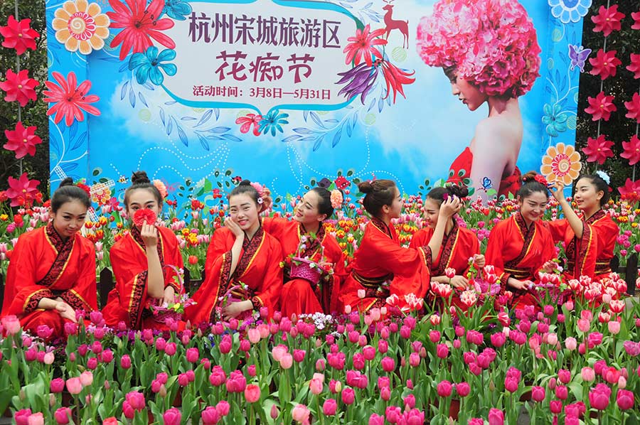 Students in traditional dresses celebrate Women's Day