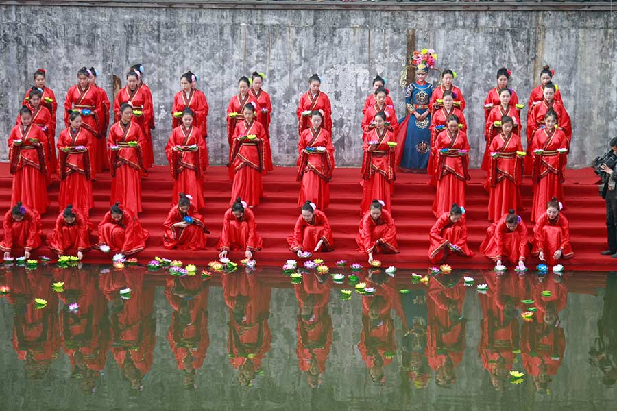 Students in traditional dresses celebrate Women's Day