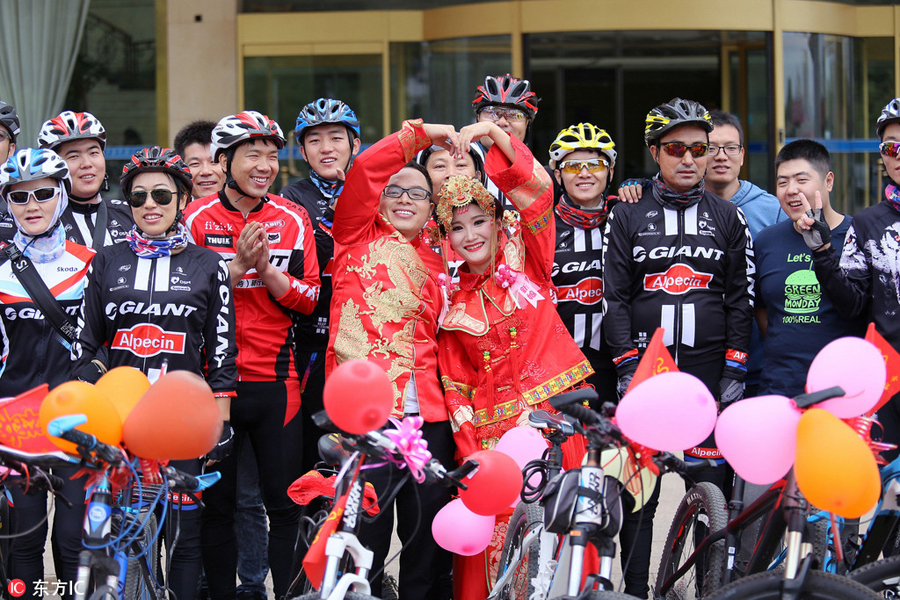 Groom and bride cycle their way to wedding