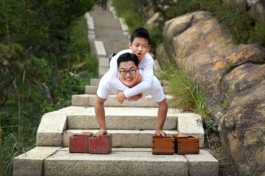 Legless man and boy climb a mountain together