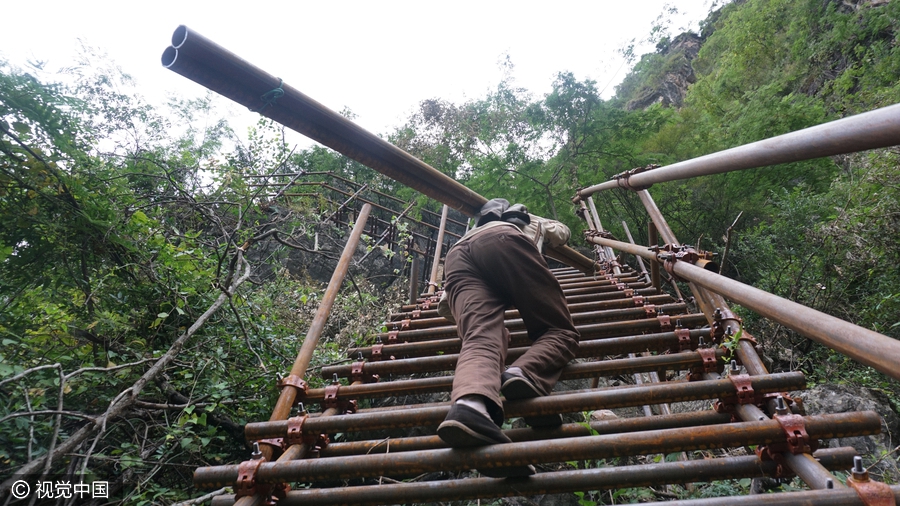 Villagers build ladder on cliff with 1,500 steel pipes