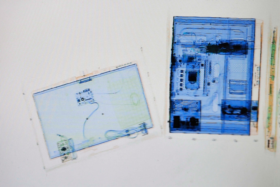 X-ray scanner reveals passangers' luggage for home journey during Spring Festival