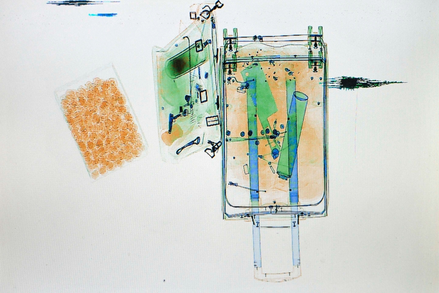 X-ray scanner reveals passangers' luggage for home journey during Spring Festival