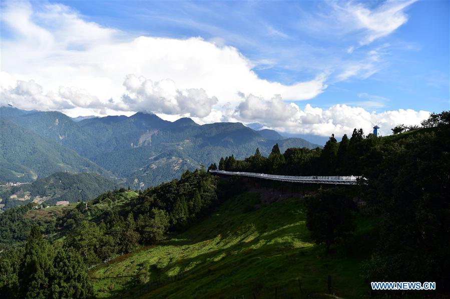 People enjoy scenery at high altitude sight-seeing footpath