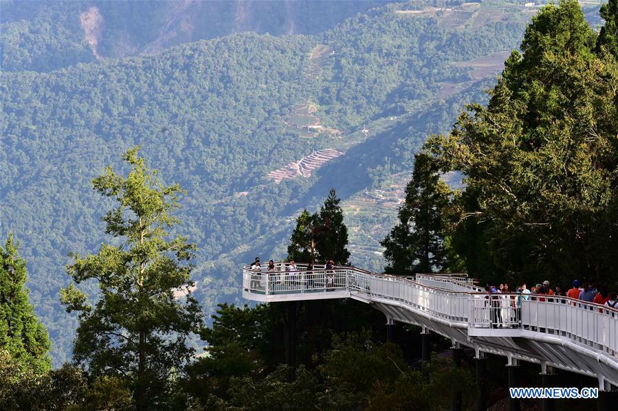 People enjoy scenery at high altitude sight-seeing footpath