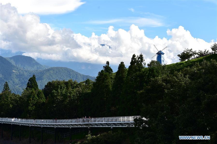 People enjoy scenery at high altitude sight-seeing footpath