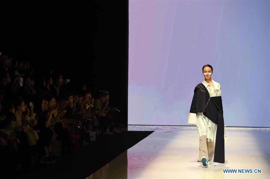 Models present fashion designs of graduates in Beijing