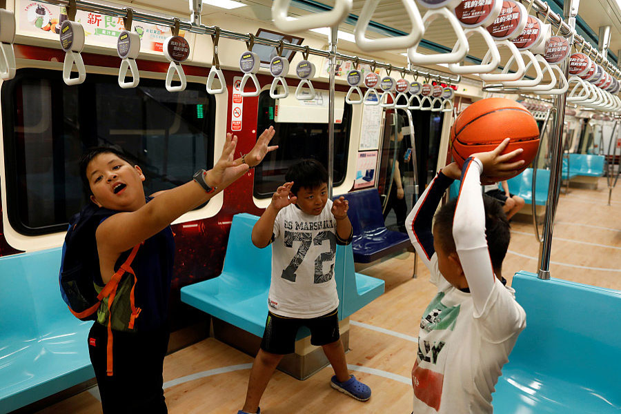 Commuters go for a swim on sports-themed trains in Taipei