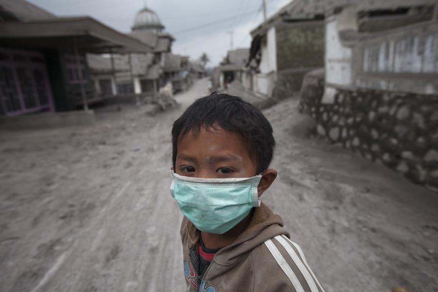 People clear volcano ash in Indonesia