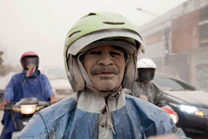 People clear volcano ash in Indonesia